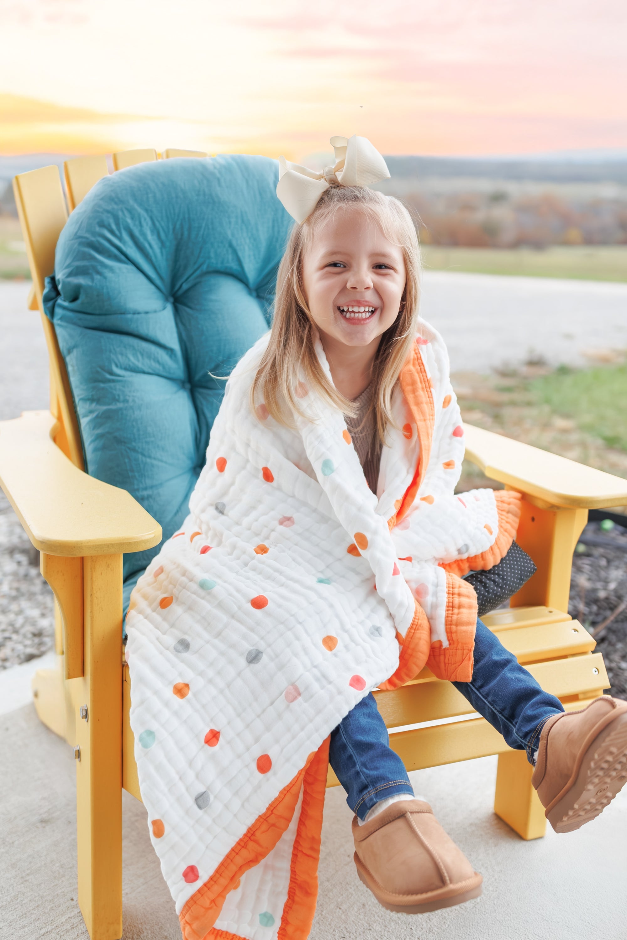 Kid's Blanket by Natchiketa in Bright Dot print with little girl sitting on a chair outside