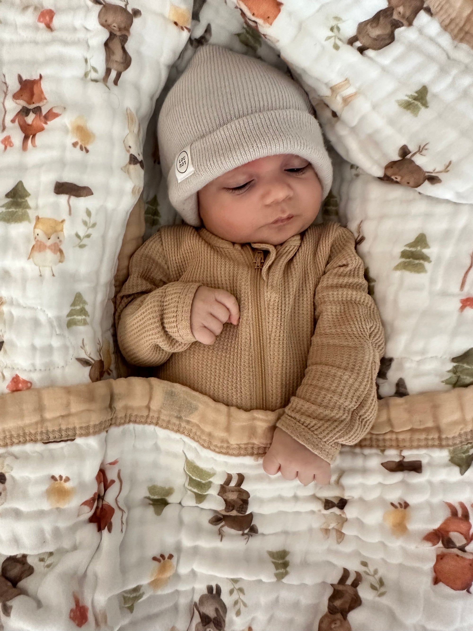 Baby sleeping and wrapped in Natchiketa Organic muslin blanket