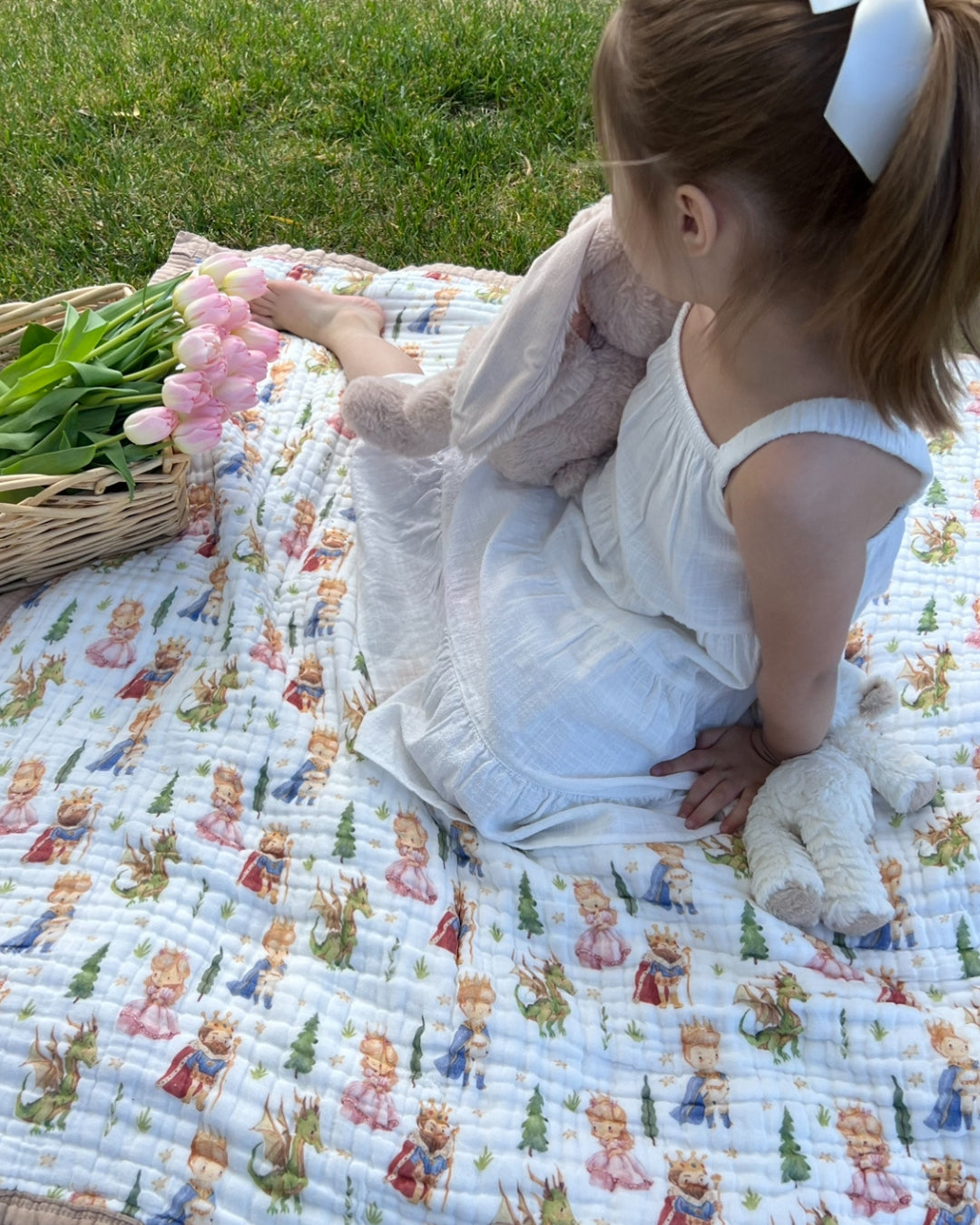 Child sitting on the natchiketa organic blanket